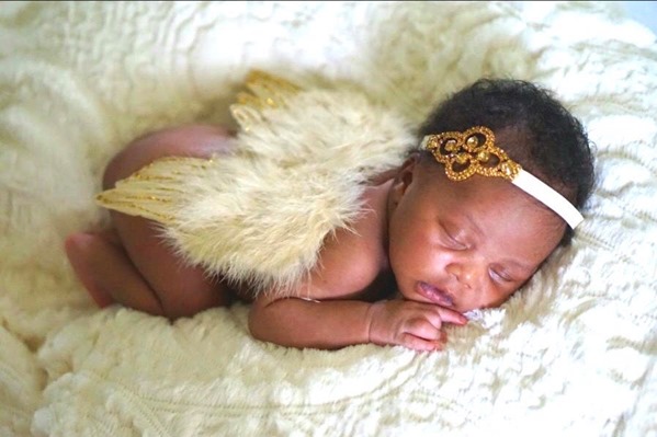 "Peaceful sleeping newborn - A precious baby peacefully asleep, wrapped in a cozy blanket."